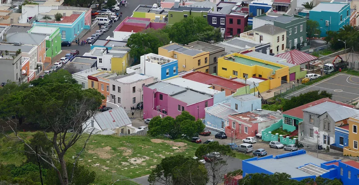 A steep Bo-Kaap street lined with flat-roofed houses painted in vivid colours