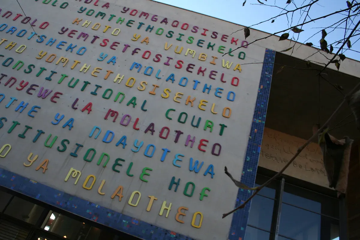 The Constitutional Court entrance with the words 'Constitutional Court' carved in South Africa's eleven official languages