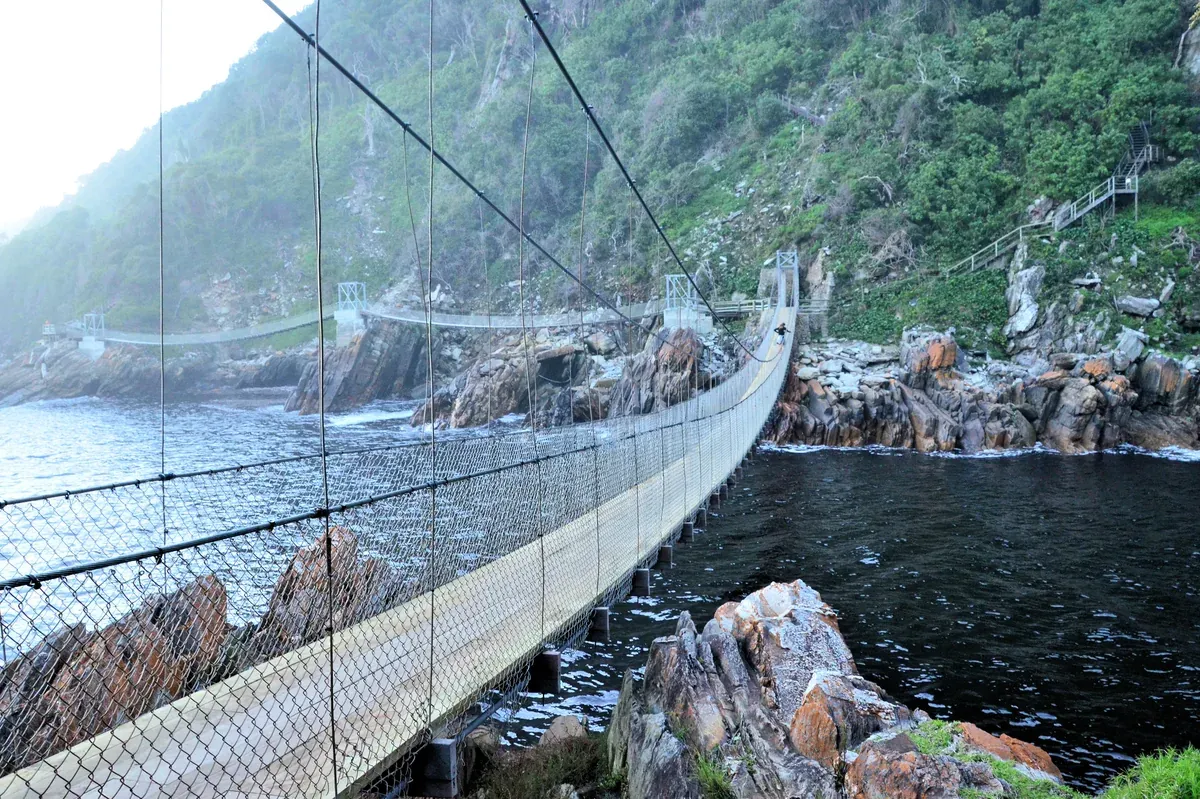 The Storms River Mouth suspension bridge in Tsitsikamma, a highlight of South Africa Garden Route
