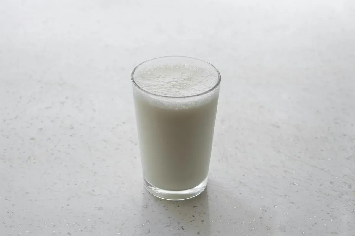 A glass of thick, freshly poured cultured milk