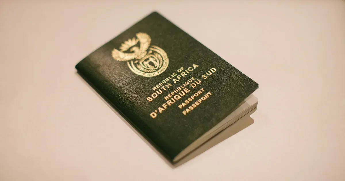 A South African passport photographed on a plain background